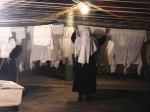 Sister hanging the clothes to dry